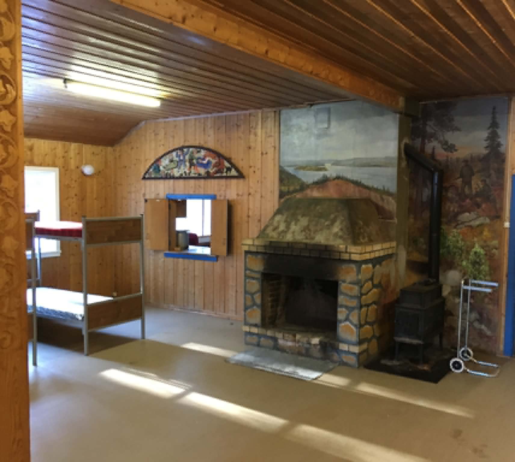 Interiøret i Heimevernshytta i Avgrunnsdalen, med peis og veggmalerier